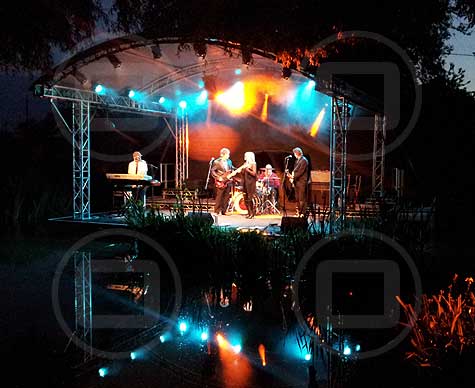 6m arc roof stage over water at Sunningwell Festival.